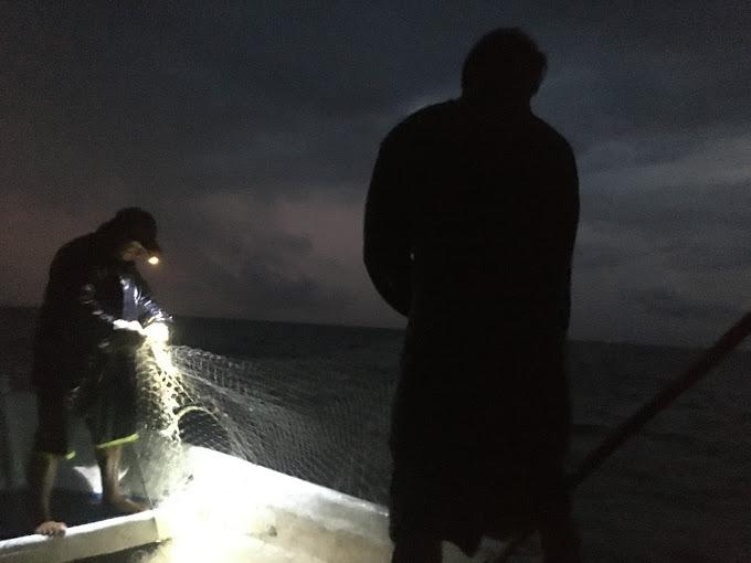 Figure 2: Small-scale fishers work through a night storm in the Costa Rica tropics.